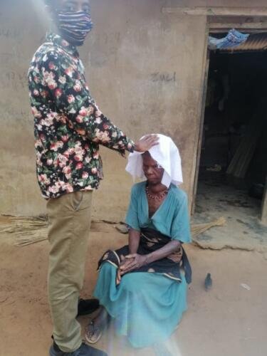Student Emmanuel praying for the sick 