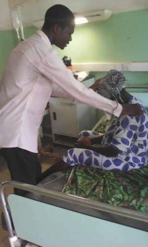 Student Mawulolo praying for the sick at the hospital