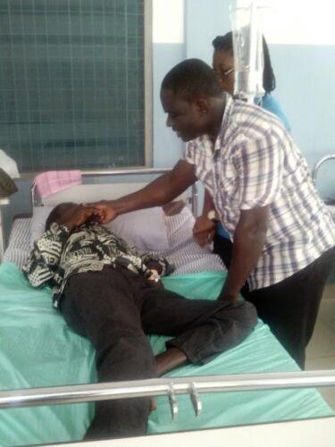 Student Sammy praying for the sick at the hospital